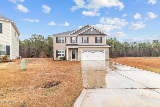 front facade with a garage and a front lawn