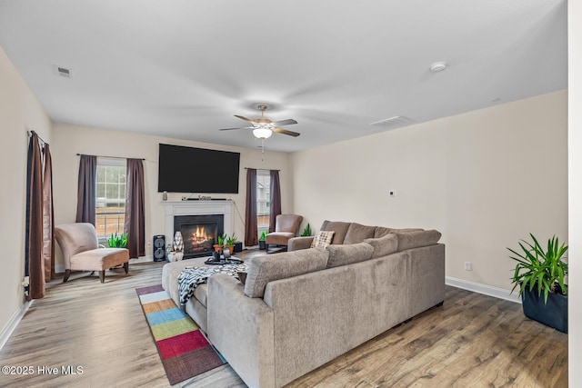 living room featuring wood-type flooring and ceiling fan