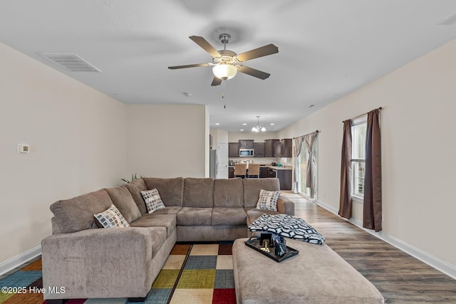 living room featuring ceiling fan and dark hardwood / wood-style flooring