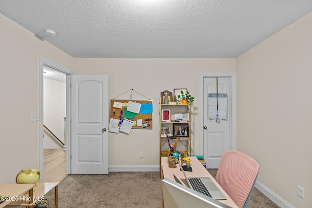 home office with light carpet and a textured ceiling