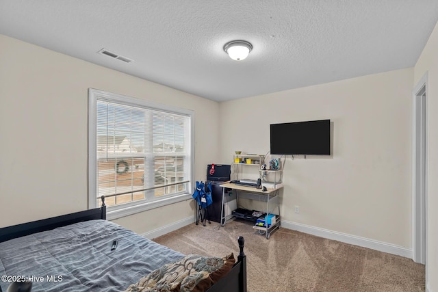 carpeted bedroom featuring a textured ceiling