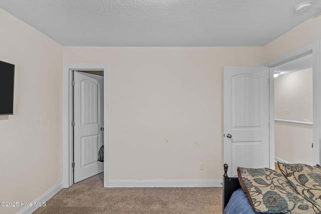 carpeted bedroom with a textured ceiling