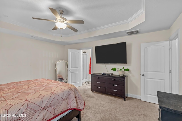 bedroom featuring ceiling fan, ornamental molding, a raised ceiling, and light colored carpet