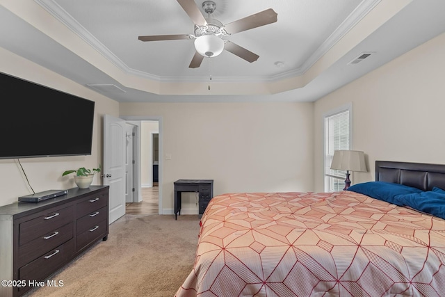 bedroom featuring crown molding, light colored carpet, a raised ceiling, and ceiling fan