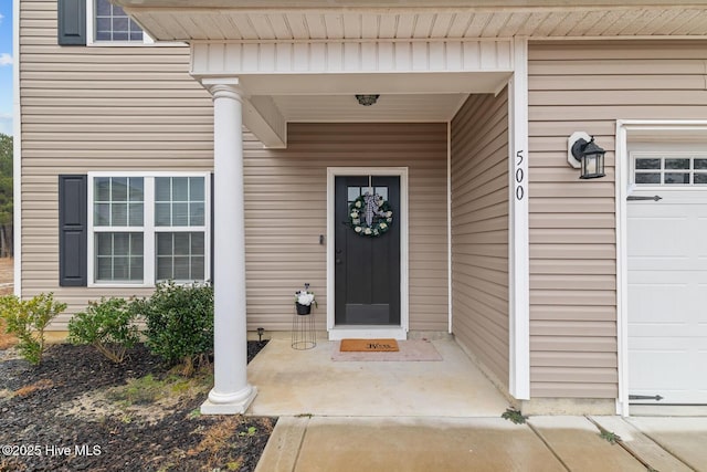 view of exterior entry with a garage