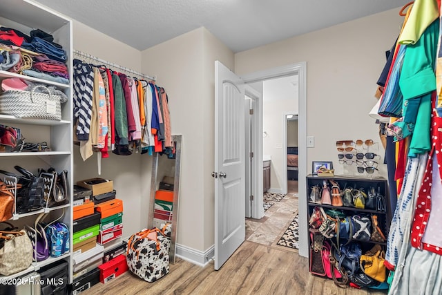 spacious closet featuring light hardwood / wood-style floors