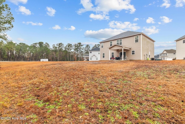 rear view of house with a lawn