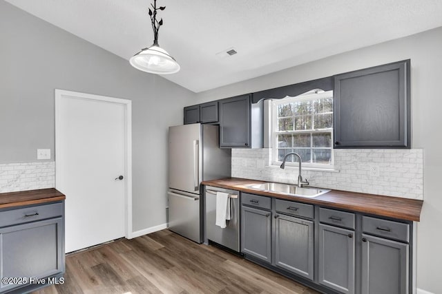 kitchen with wood counters, sink, and stainless steel appliances