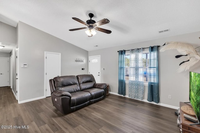 living room featuring lofted ceiling, dark hardwood / wood-style floors, and ceiling fan