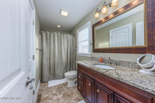 bathroom featuring vanity and toilet