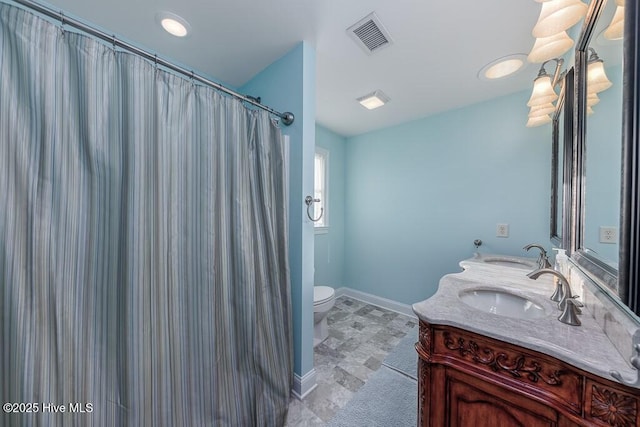 bathroom featuring vanity, walk in shower, and toilet