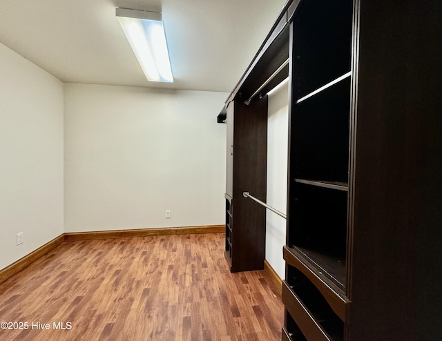 spacious closet featuring hardwood / wood-style flooring