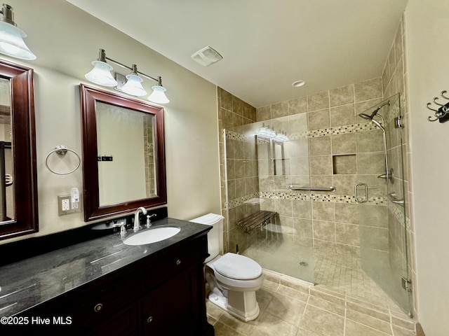 bathroom with an enclosed shower, vanity, tile patterned flooring, and toilet