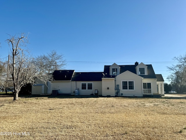 view of front of home featuring central AC unit and a front lawn