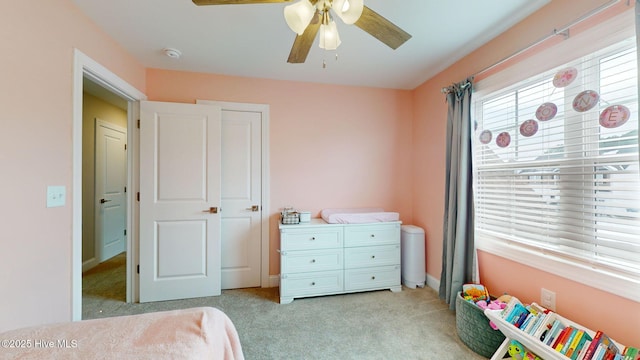 bedroom with light colored carpet and ceiling fan