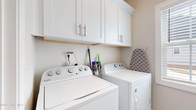 washroom with cabinets and washer and dryer