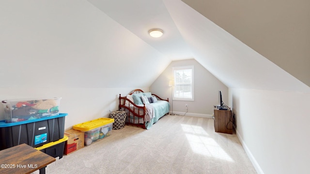 carpeted bedroom featuring lofted ceiling