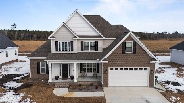 view of front of home with a garage and a porch