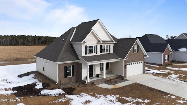 view of front of property featuring a porch and a garage