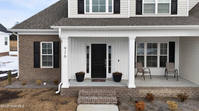 doorway to property featuring covered porch