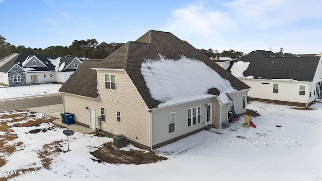 view of snowy exterior featuring central AC