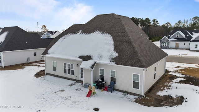 view of snow covered rear of property