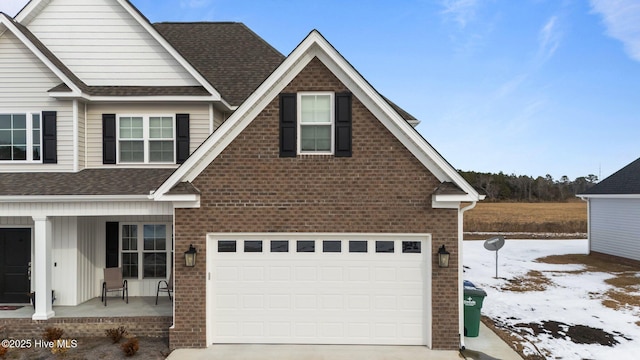 view of front of property with a garage and covered porch