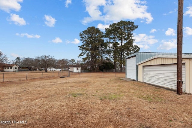 view of yard featuring a garage and an outdoor structure