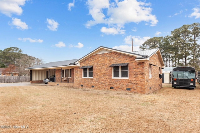 back of property with covered porch and a lawn