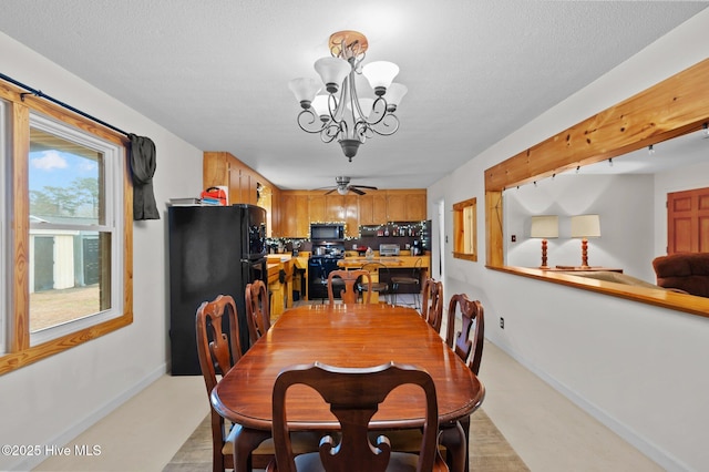 dining space featuring a notable chandelier and a textured ceiling