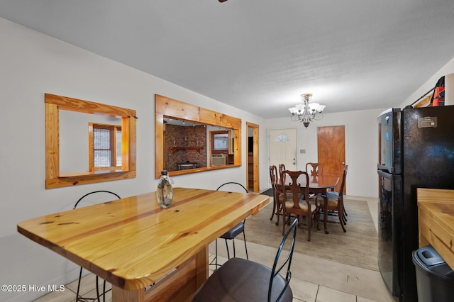 tiled dining area with a chandelier