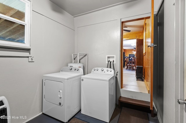 laundry room featuring wooden walls and independent washer and dryer