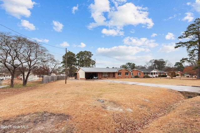 view of front facade with a front lawn and a carport