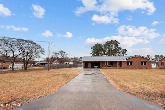 ranch-style home with a carport and a front yard