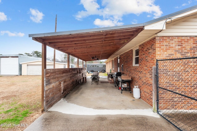 view of vehicle parking featuring ceiling fan and a garage