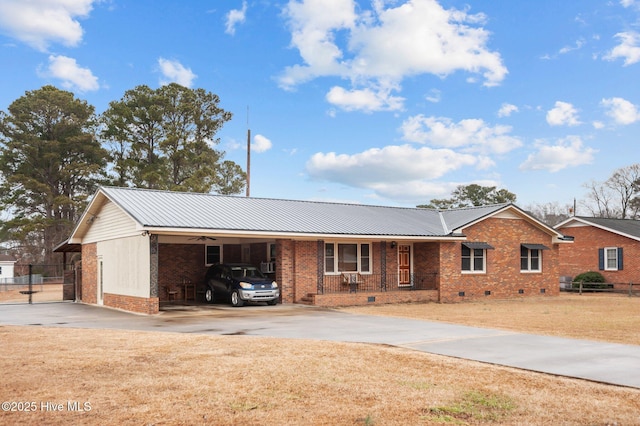 ranch-style home with a carport, a porch, and a front yard