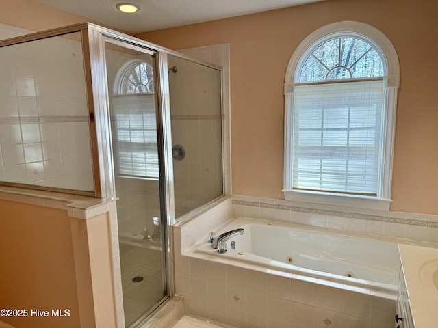 full bathroom featuring a shower stall and a whirlpool tub