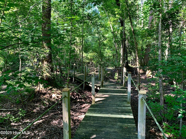 view of dock with a wooded view