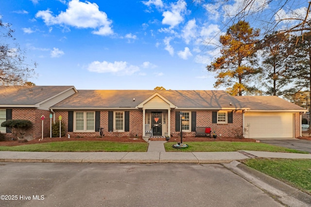 single story home with a garage and a front lawn