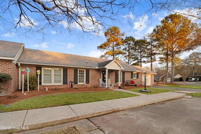 ranch-style home with a garage and a front yard