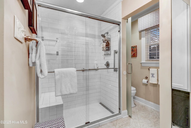 bathroom featuring an enclosed shower and toilet