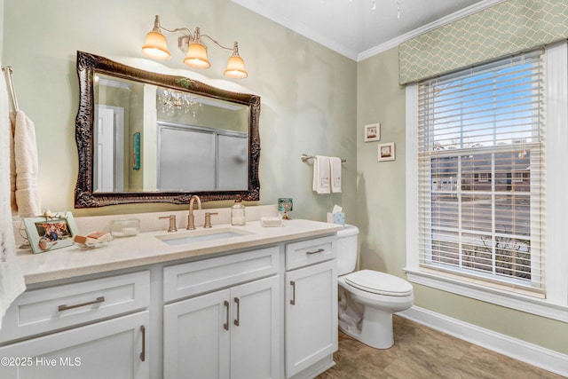 bathroom with ornamental molding, toilet, and vanity