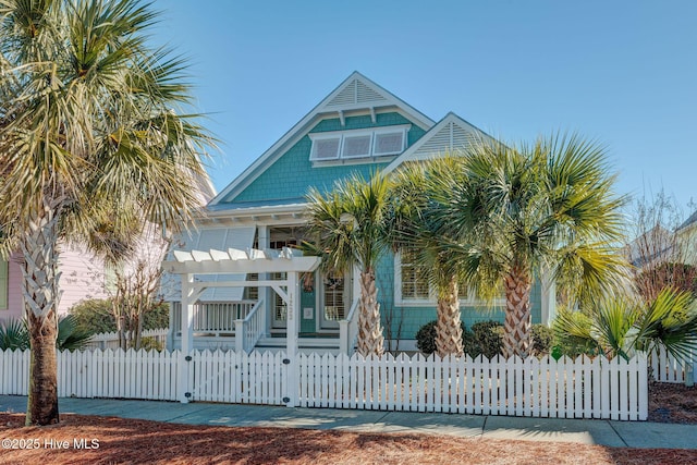 raised beach house featuring a pergola