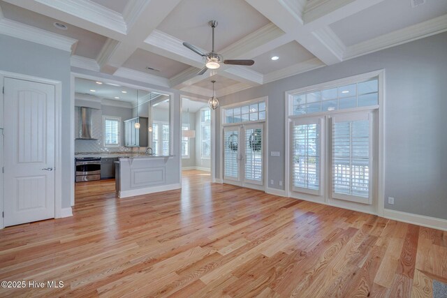 empty room with vaulted ceiling and light hardwood / wood-style floors