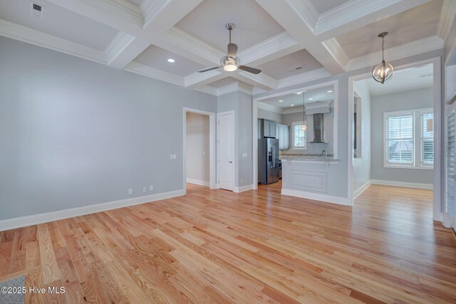 empty room featuring crown molding, coffered ceiling, hardwood / wood-style floors, and beam ceiling