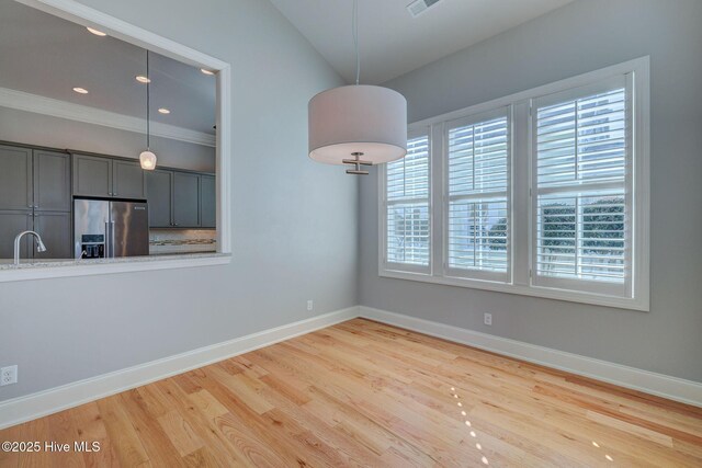 kitchen with sink, hanging light fixtures, beamed ceiling, stainless steel appliances, and decorative backsplash