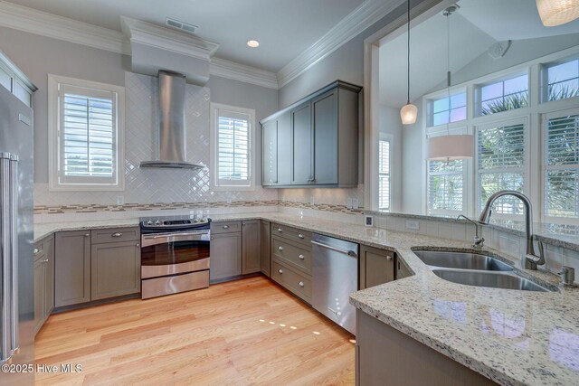 kitchen with sink, decorative backsplash, light stone countertops, and appliances with stainless steel finishes