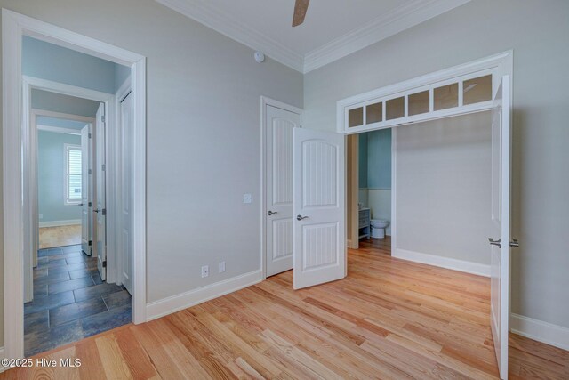 unfurnished room featuring crown molding, ceiling fan, and light wood-type flooring