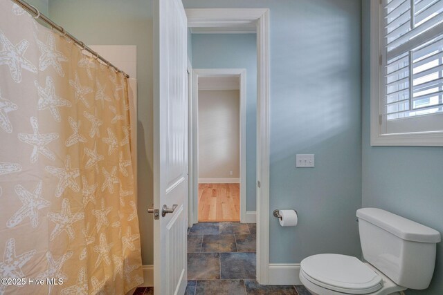 unfurnished bedroom featuring connected bathroom, ornamental molding, and light hardwood / wood-style floors