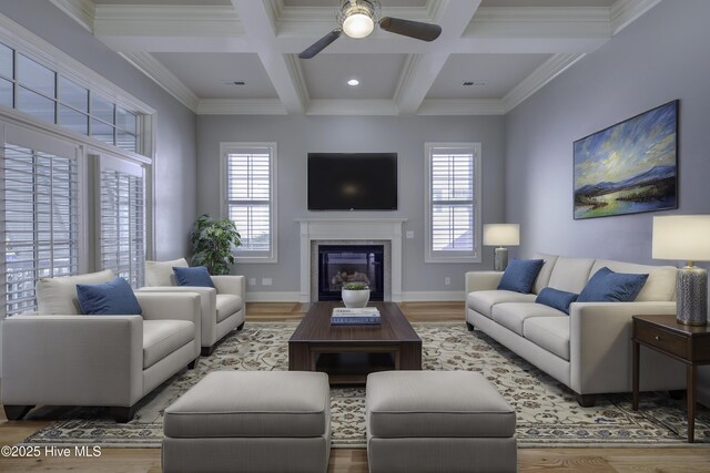 unfurnished living room featuring ceiling fan with notable chandelier, beamed ceiling, coffered ceiling, light hardwood / wood-style floors, and french doors